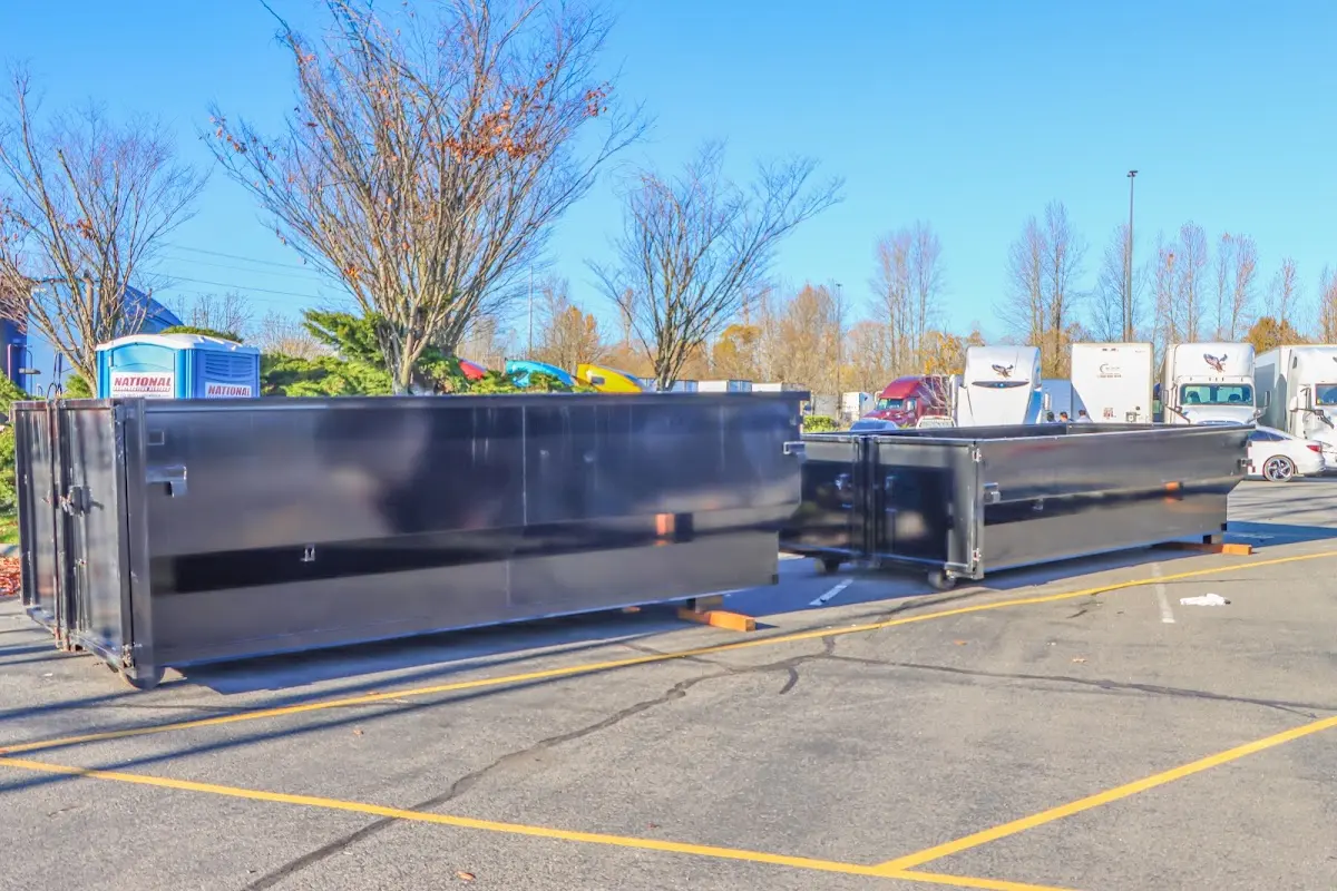 Professional dumpster rental service with roll-off container on residential driveway in Jersey City